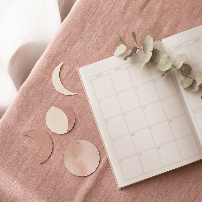 An open planner and a phone on a nightstand, late at night