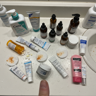 Bathroom counter covered in 14 skincare products