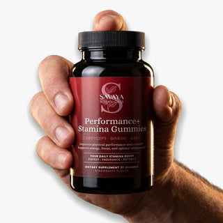 Performance+ Stamina Gummies held in hand on a clean light background
