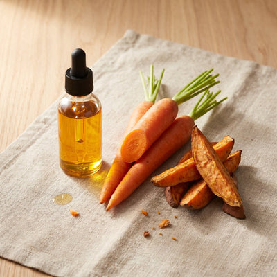 Organic vitamin A represented by carrots and golden oil dropper
